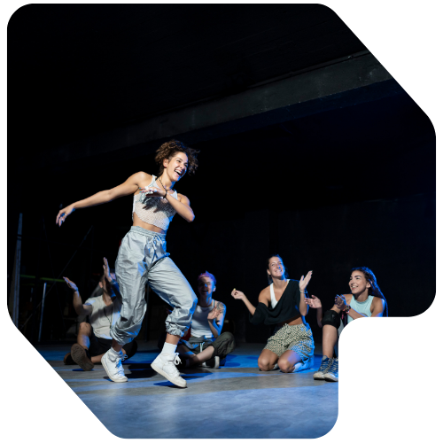 Young dancers and singers performing on stage at a Wigan talent competition